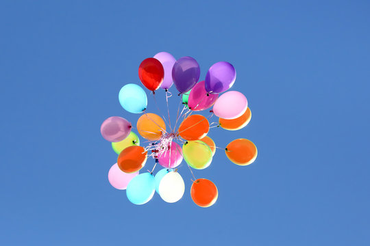 bunch of colorful balloons against the blue sky