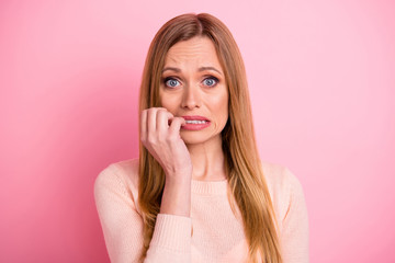 Portrait of disappointed youth teeth bite fingers fail isolated over pink background