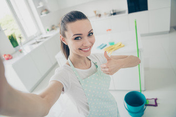 Closeup self portrait of cheerful careless carefree girl having finished her cleaning up house and...