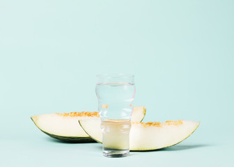 Sliced melon with glass of water