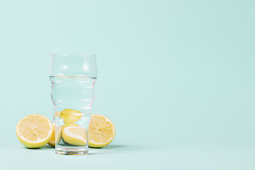 Lemons and glass on blue background