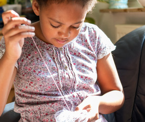 girl concentrating on sewing 