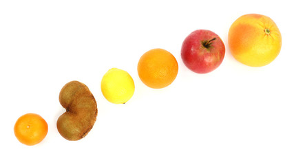 different fruit on a sloping surface on a white background