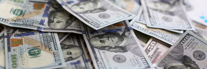 Big pile of US money lying down in random order closeup