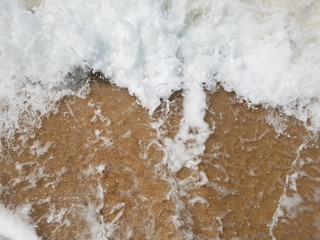 Deserted paradise beach with foamy waves