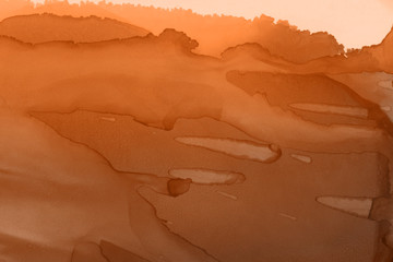 Hand painted alcohol ink background. Abstract delicate orange texture. Contemporary autumn wallpaper. 