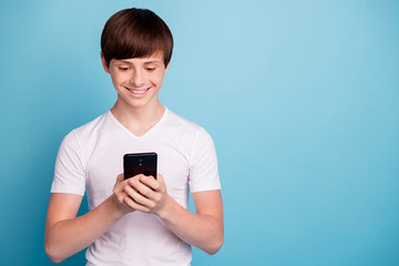 Photo of smiling rejoicing boy having received message from his classmate girl he has liked since...