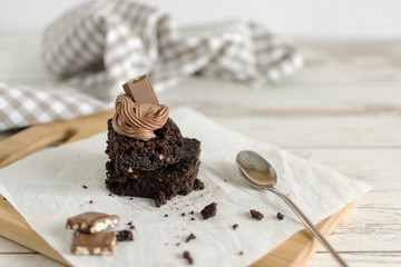 A stack of chocolate brownies on wooden background, homemade bakery and dessert.