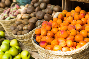 appetizing apricots in wicker baskets on counter in market