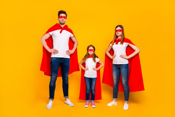 Family spending leisure time playing cartoon characters wear superhero costume isolated yellow...