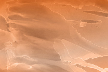 Hand painted alcohol ink background. Abstract delicate orange texture. Contemporary autumn wallpaper. 