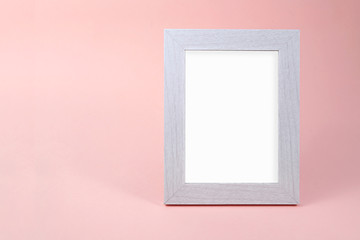 Blank white picture frame on pink background