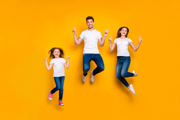 Fototapeta na wymiar Full length body size view of three nice attractive slim fit sporty lovely cheerful cheery person having fun active activity motion showing v-sign isolated over bright vivid shine yellow background