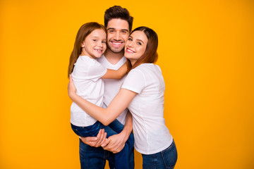 Portrait of three nice attractive charming cute lovely gentle kind cheerful cheery person cuddling embracing spending day weekend isolated over bright vivid shine yellow background