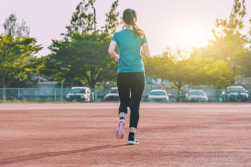 Obraz premium Runner Women jogging or running in evening at sunlight