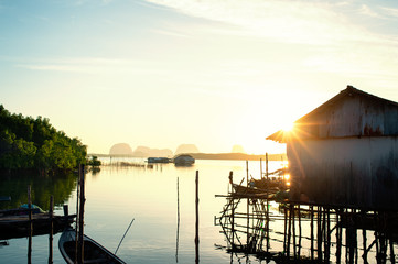 Fishermen village on the seashore..House of fishermen family with sunray on roof and refelecting on...