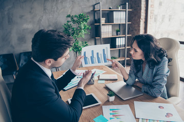Photo of two business people lady and guy discussing earnings plan sitting office chairs workshop