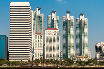 Fototapeta na wymiar Skyscraper, office blocks and condominium at the Benjakitti Park in the Khlong Toei district of the metropolis Bangkok. The urban Park was a former industrial area, opened in 2004
