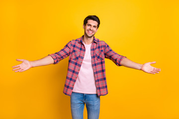 Photo of man opening his arms wide to hug his girlfriend he has not seen for ages while isolated with yellow background