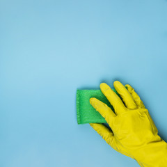 Close-up person cleaning with green sponge