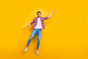Fototapeta na wymiar Full length body size photo of rejoicing overjoyed enjoying man wearing jeans denim pretending to be holding balloon and flying with it isolated with vivid background