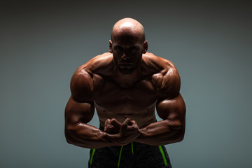Fototapeta na wymiar Brutal strong athletic bodybuilding men posing in studio. Bodybuilding and healty life concept. 