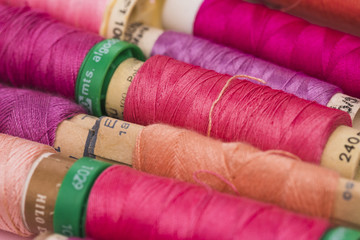 Line of reels of warm colors yarn