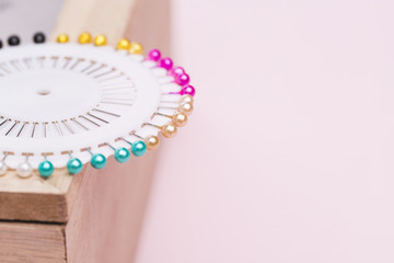 White pin box with colorful needles