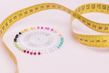 Measuring tape with colorful needles