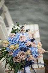 Bouquet of the bride with a powdery rose and blue hydrangea. Wedding floristry.