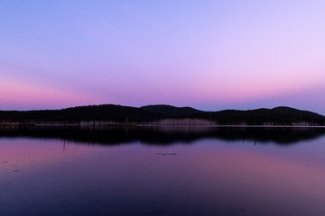 A perfect reflection during a pink sunset a lake on a clear and sunny day in Queensland, Australia