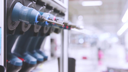 Selective focus close up on a set of electric powered screwdrivers with factory copy space background, cordless drill screw driver.