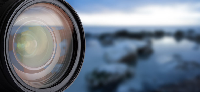 DSLR Camera Lens Isolated. Closeup Reflections in Lens. Blurred Background and Abstract Bokeh.
