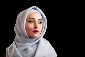 Beautiful young Middle eastern Woman wearing Abaya. pink lips. Vertical Portrait close-up, high...