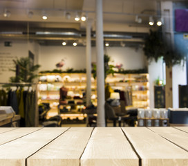 Wooden table with blurred restaurant scene