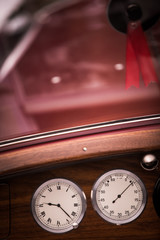 Tachometer and a clock on a vintage car's dashboard
