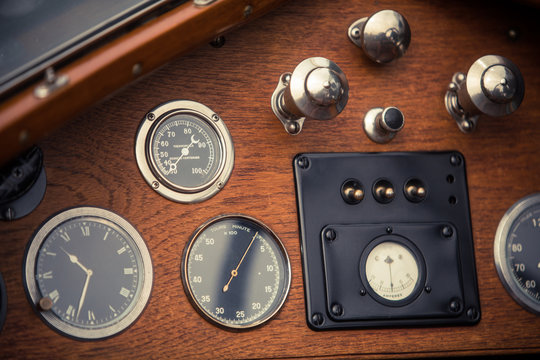 Tachometer and a clock on a vintage car's dashboard
