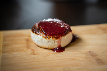 Close up shot of fried camemebert cheese with rapsberry dressing