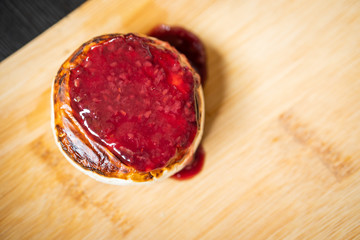 Close up shot of fried camemebert cheese with rapsberry dressing