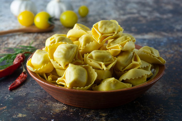 Tortelloni pasta, italian traditional pasta with meat or vegetables. Hommemade food, cooking process.