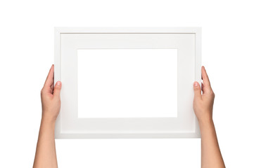 White frame. Woman hanging a frame on the wall. Empty frame template.