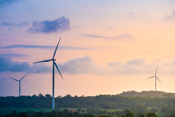 Green energy concept, eco power. Wind turbine located along the hill with the wind blowing all the...