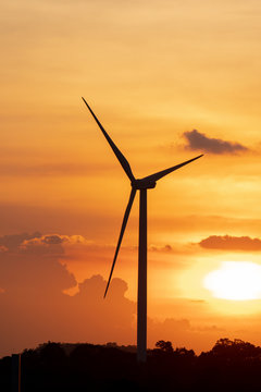 silhouette of wind turbine located on a ridge with wind blowing all the time. Making it able to effectively produce renewable electricity, which is another clean energy.