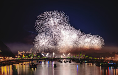Colorful silver fireworks over Budapest, River Danube with bridges, night