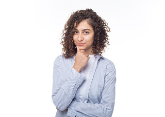 Portrait of an Indian pensive girl on a white isolated background. A young brunette woman is thinking about an idea. 