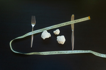 DIet concept - cauliflower wrapped with measuring tape