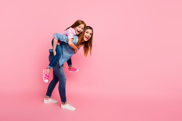 Full length photo of funny foxy little lady and her mom spending leisure time wear casual clothes isolated pink background