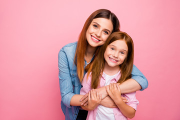 Portrait of charming ladies with long hair cuddling with beaming smile isolated over pink background