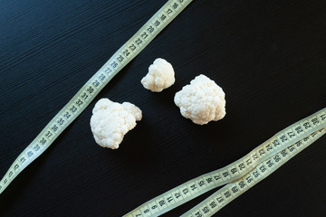 DIet concept - cauliflower wrapped with measuring tape