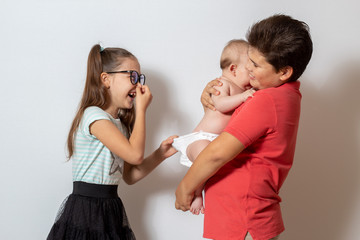 Children change the baby's diaper. Bad smell